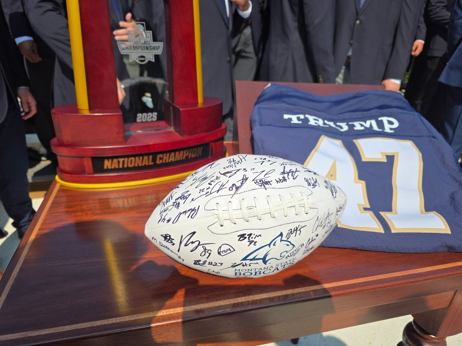 The Montana State Bobcats 2025 FCS National Champion trophy and a team-signed football on display at the White House, beside a Bobcats jersey